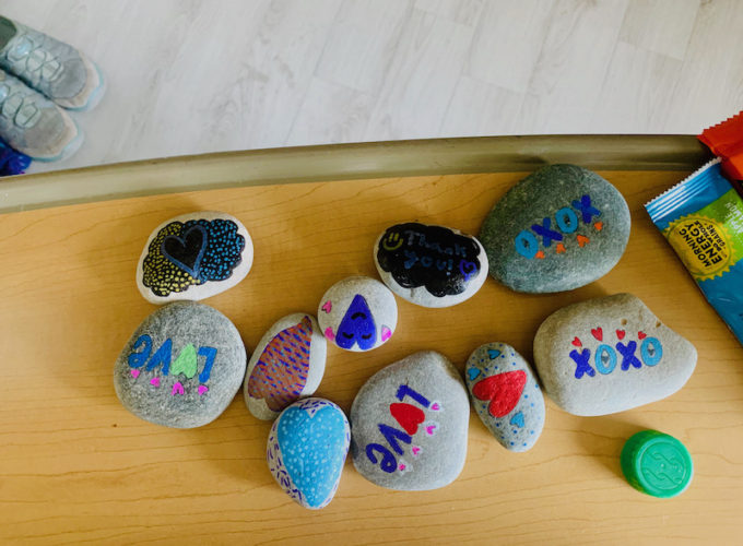 painted rocks with the words love, xoxo and hearts