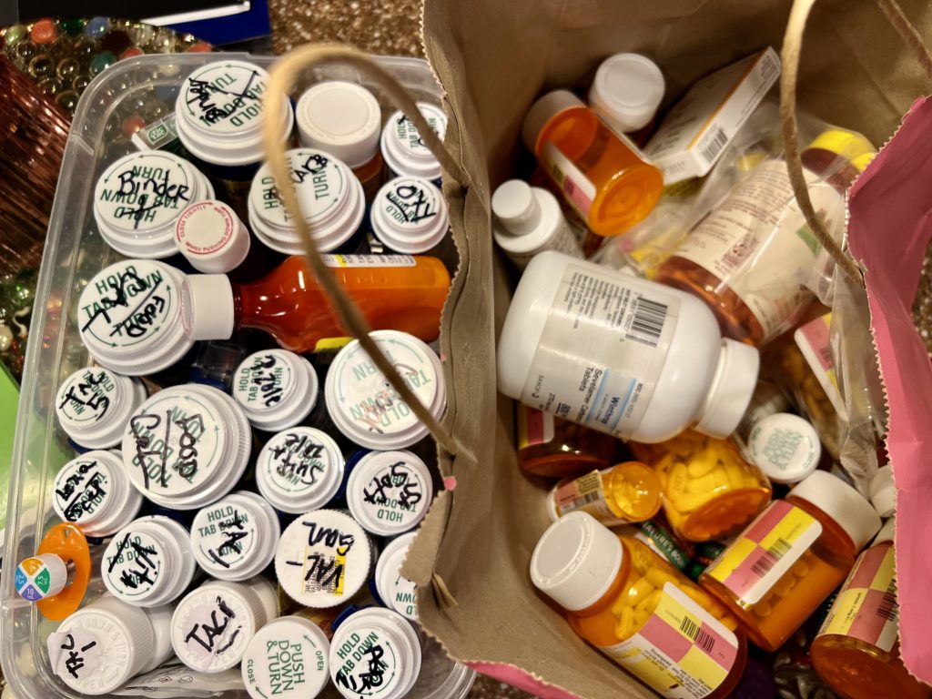 Picture of a bag of meds and a box of meds